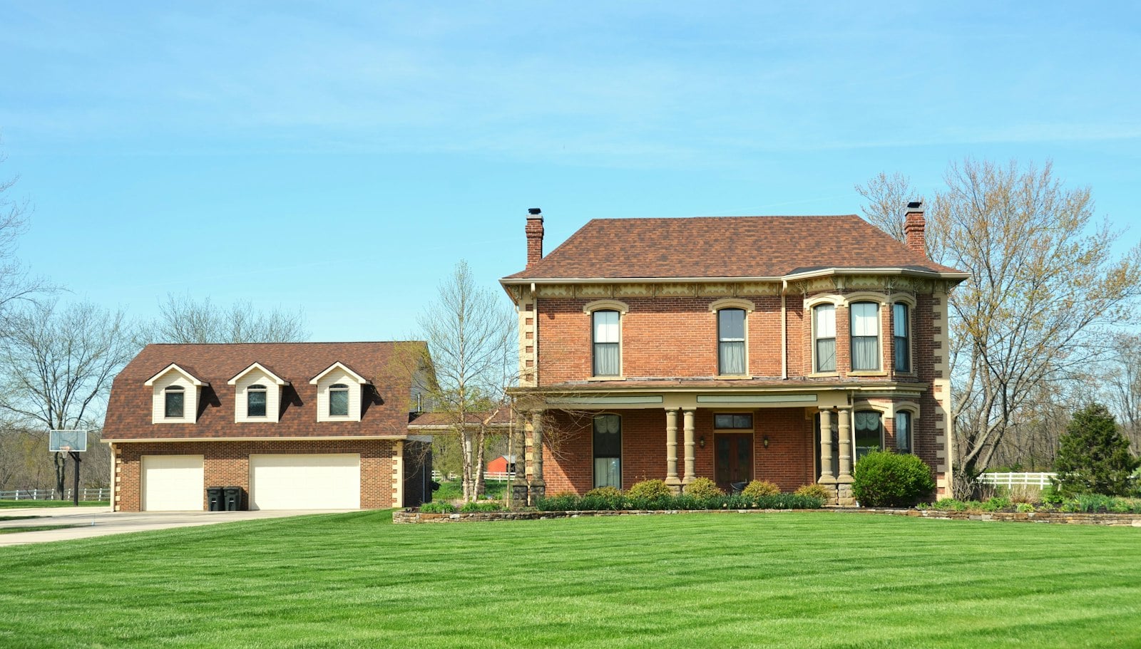 Brick house with an attached garage and green lawn